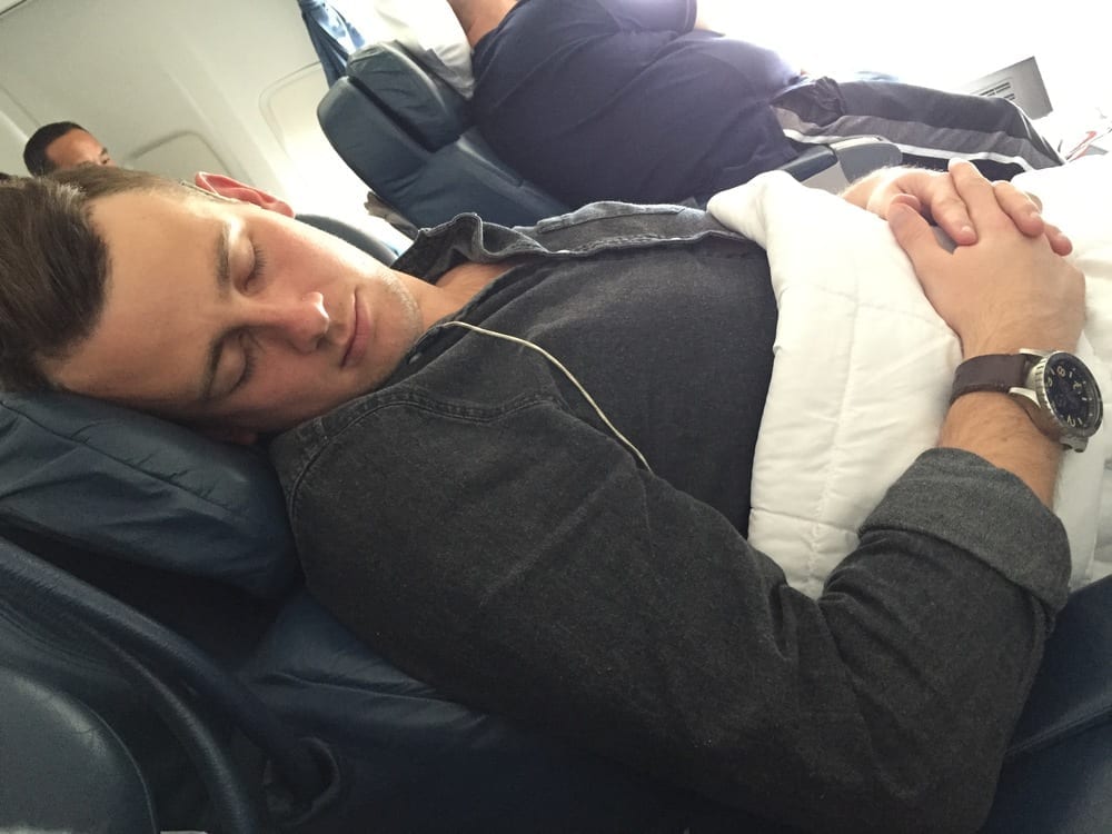 a man sleeping on an airplane
