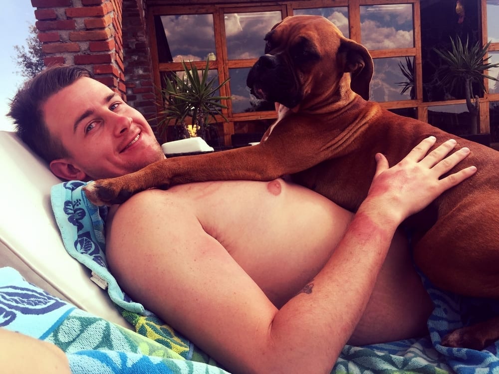 a man lying on a bed with a dog