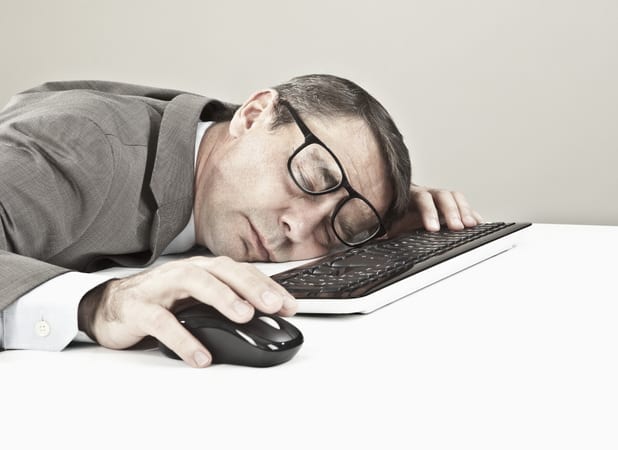 a man sleeping on a keyboard