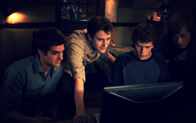 a group of men looking at a computer screen