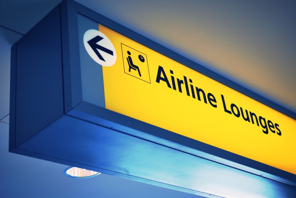 a sign with an arrow pointing to an airport