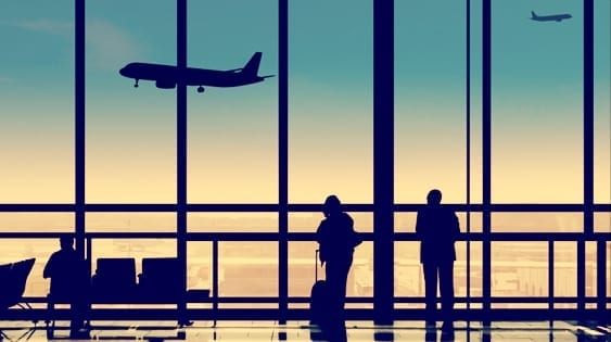 silhouette of people standing in an airport