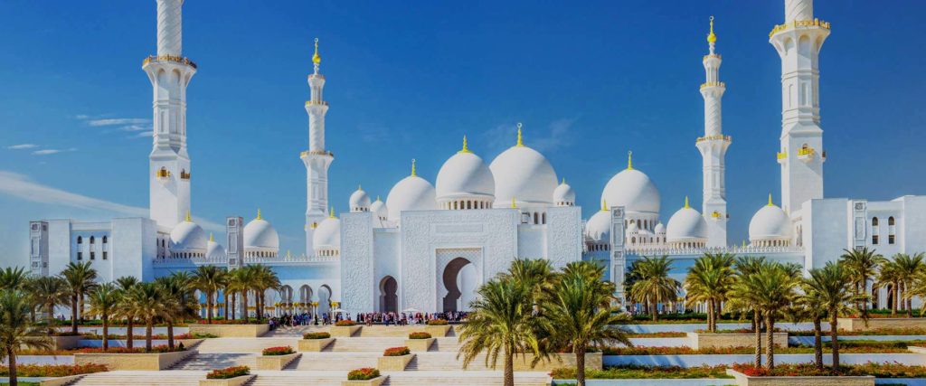 a large white building with domes and Sheikh Zayed Mosque