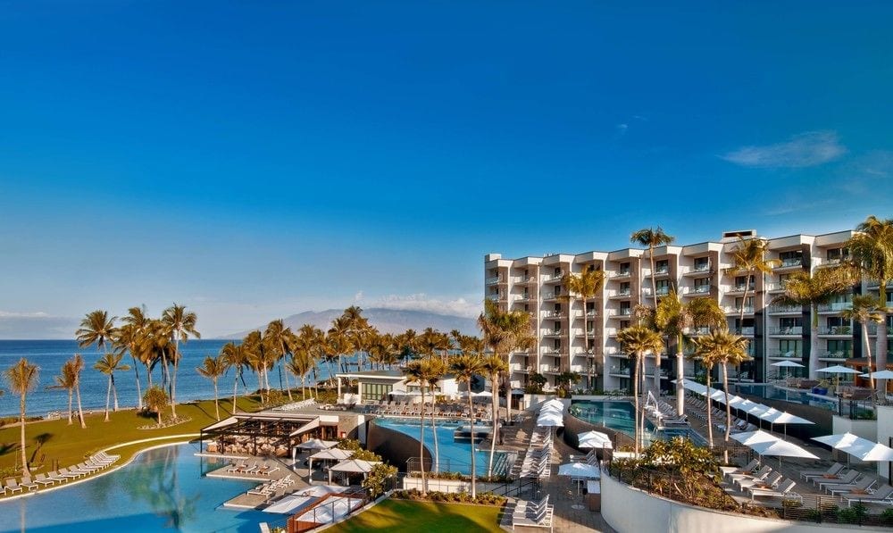 a hotel with a pool and palm trees