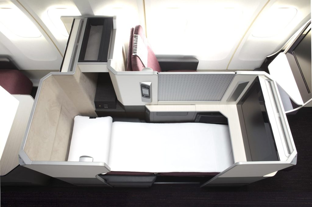 an airplane with a bed and a desk