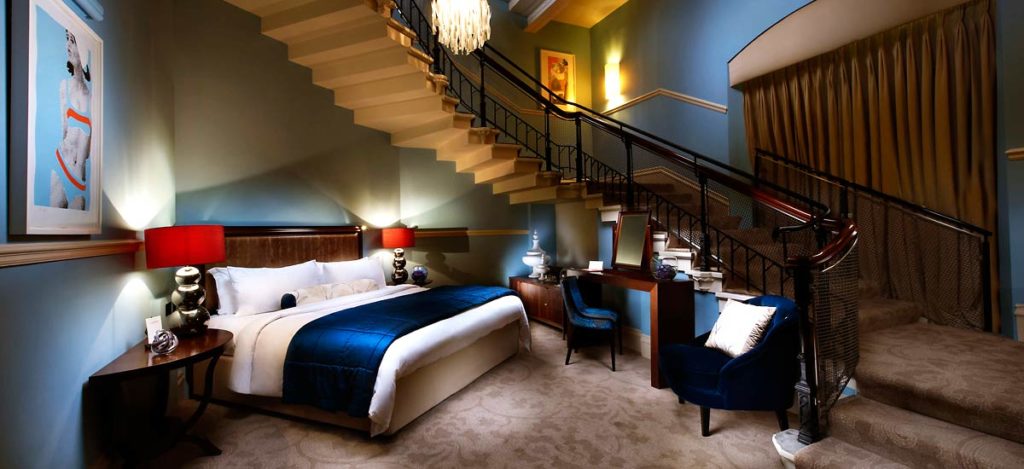 a bedroom with a staircase and a bed