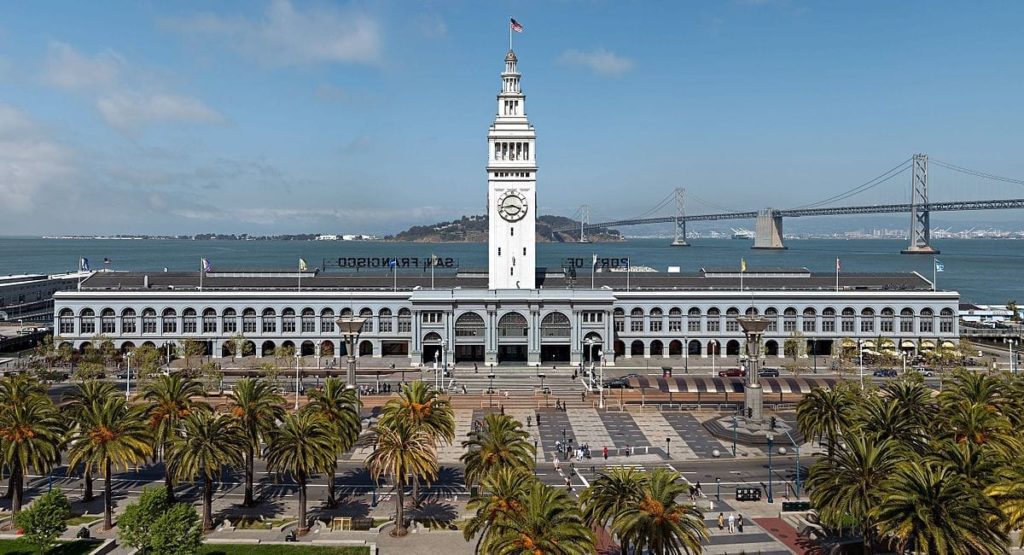 San Francisco Ferry Building with a clock tower and palm trees