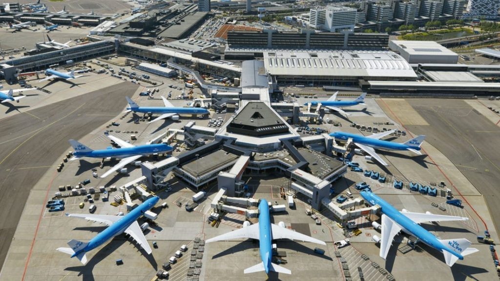 a group of blue airplanes parked at an airport