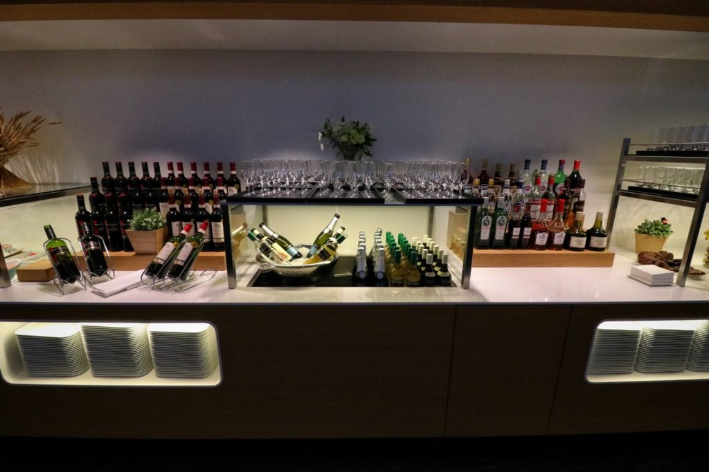 a bar with bottles of wine and glasses