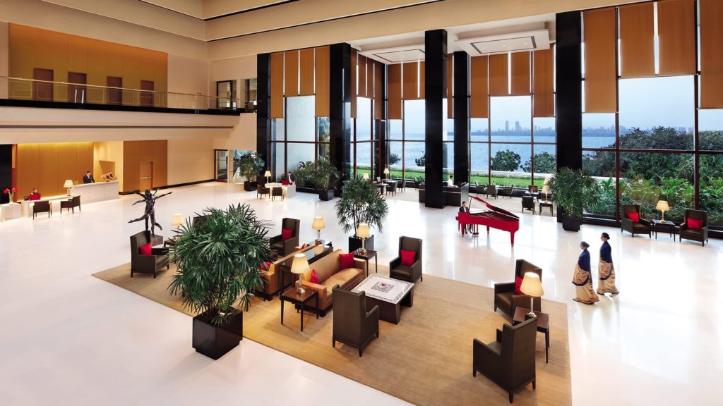 a large lobby with a piano and chairs