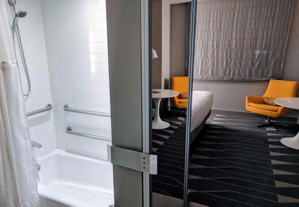 a bathroom with a bed and a tub
