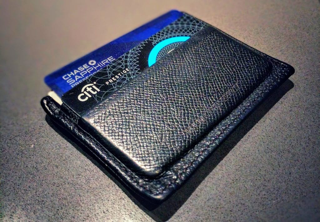 a black wallet with a blue and black design