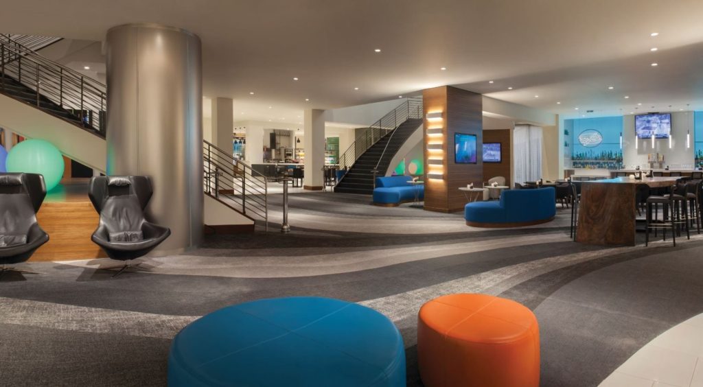 a lobby with blue and orange seats