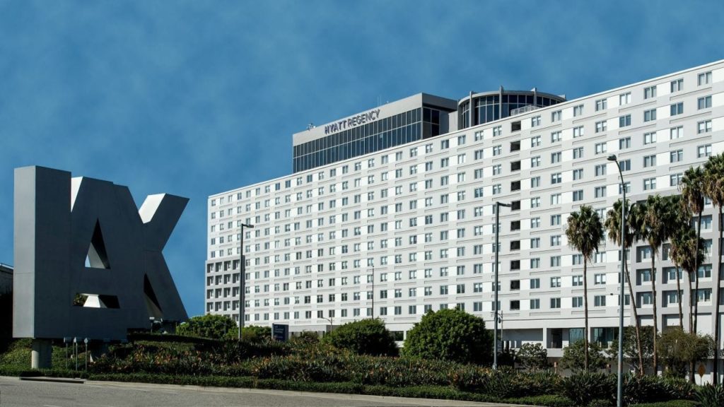 a large white building with a large x sign