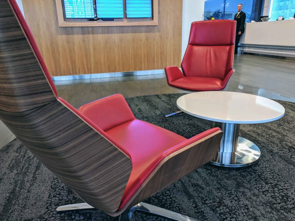 a red chairs and a white table in a room