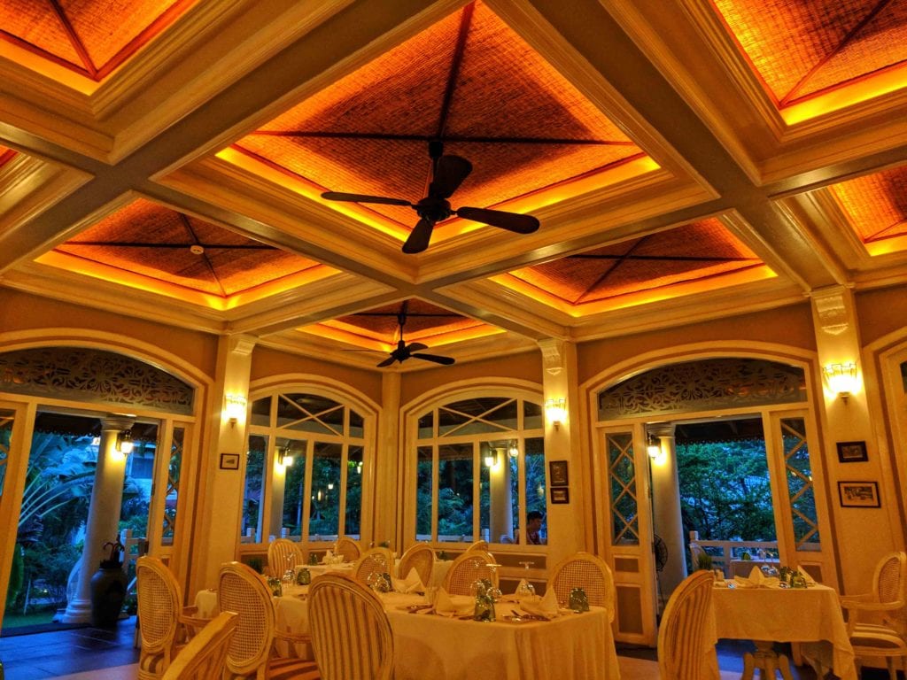 a room with tables and chairs and ceiling fans