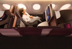 a woman sitting in a chair in a plane