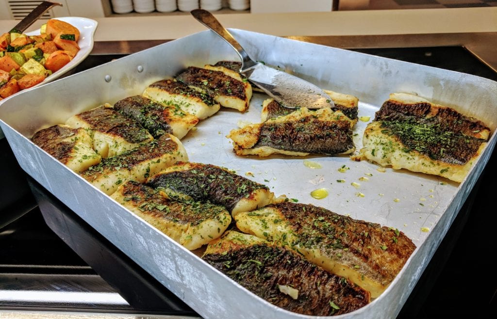 a pan of fish with a spatula