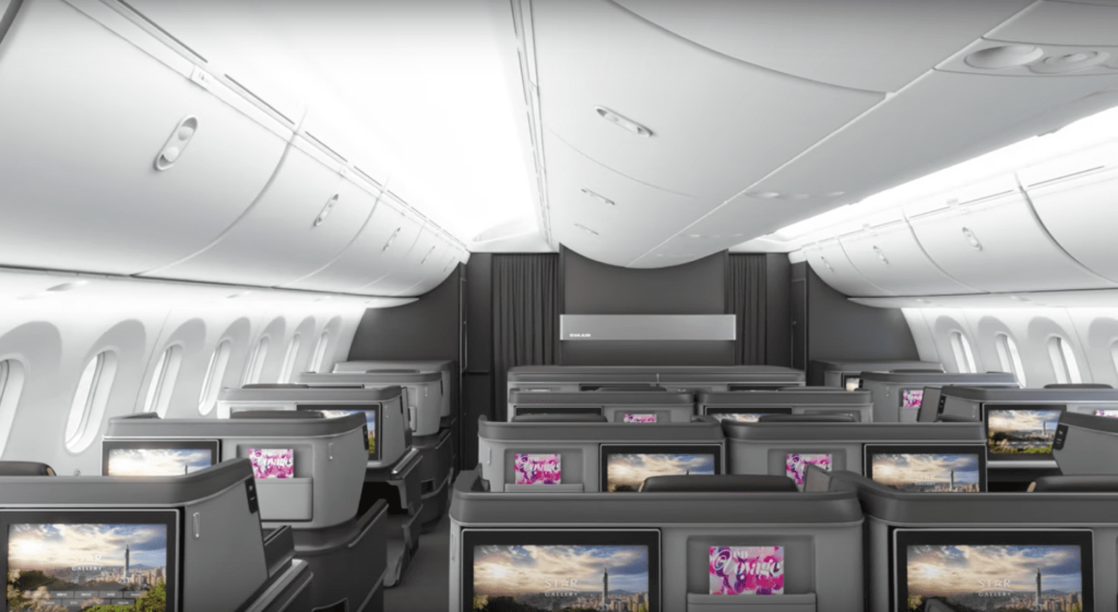 an airplane with a row of seats and a television