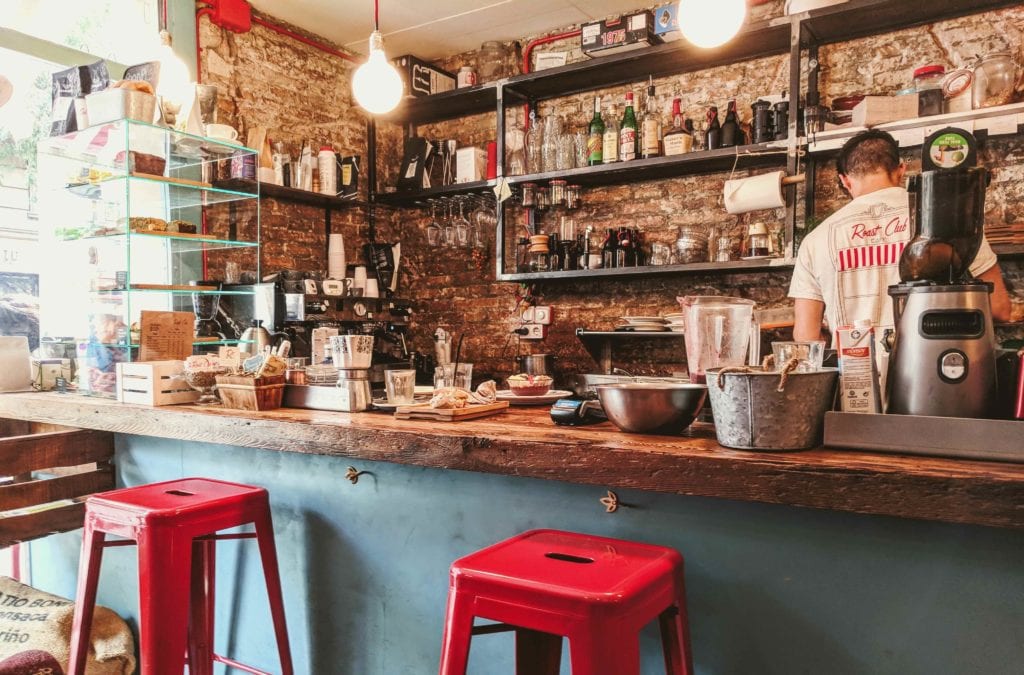 a man standing behind a counter in a restaurant