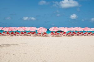 a group of chairs and umbrellas on a beach