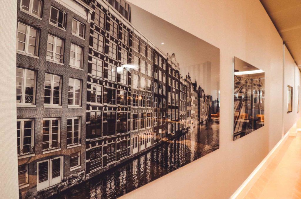a wall with a picture of buildings and a river