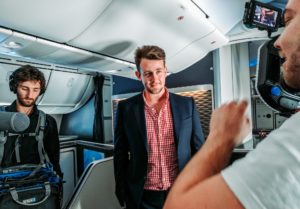 a man in a suit standing in an airplane