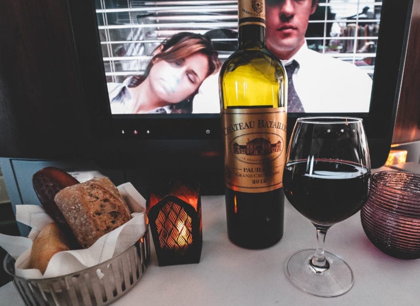 a wine bottle and a glass of wine on a table