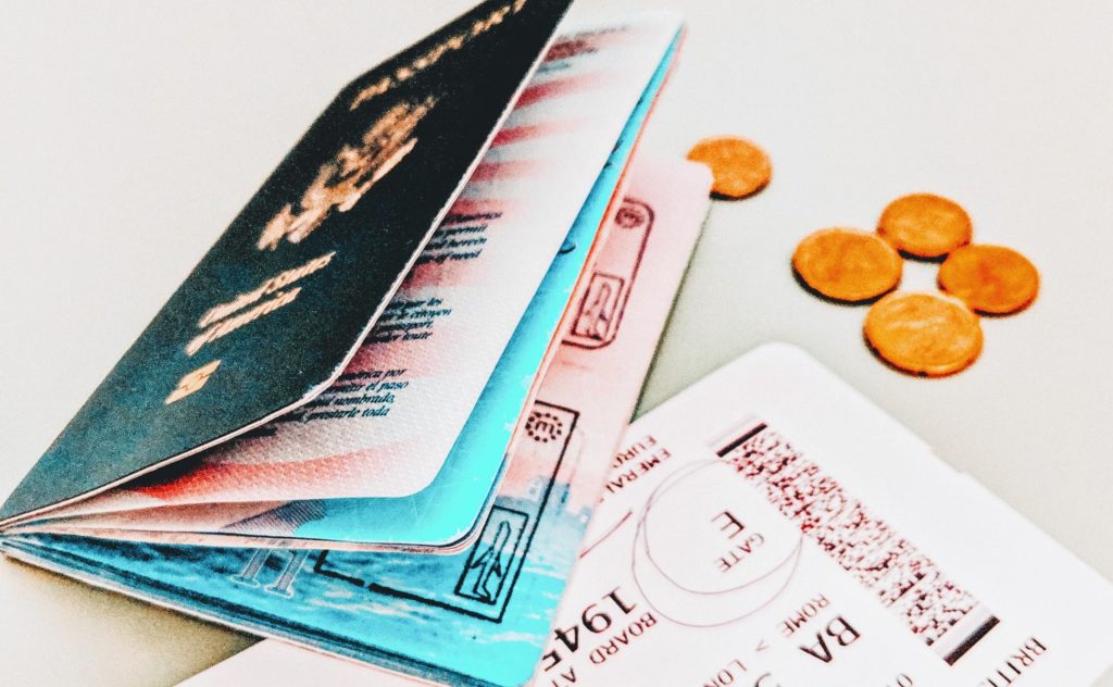 a stack of passport and coins