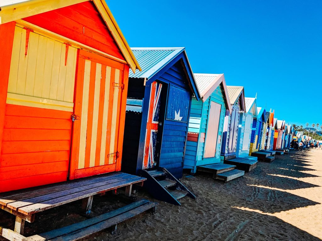 a row of colorful beach huts