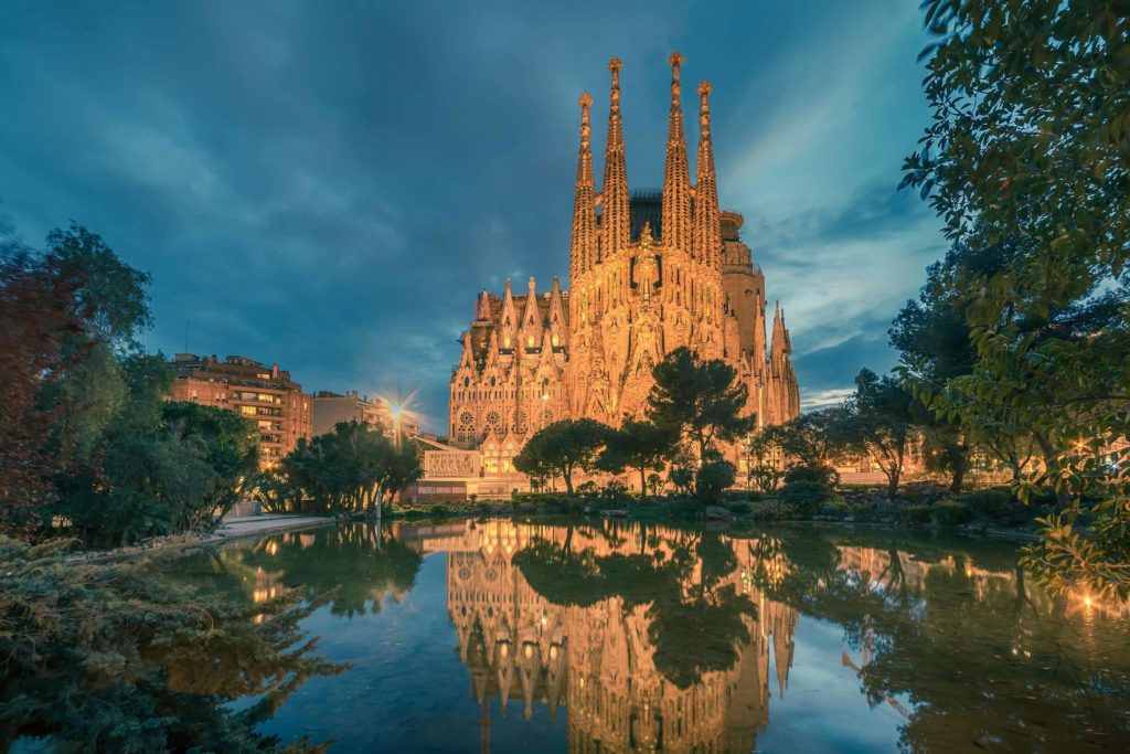 a large building with towers and a body of water