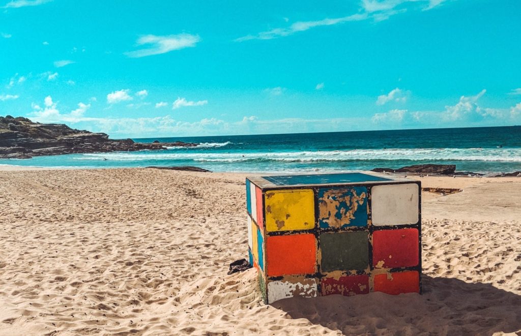 a colorful cube on a beach