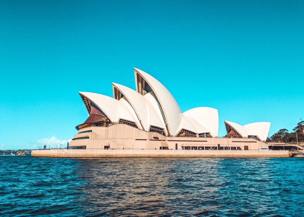 Sydney Opera House with pointed roof and a body of water