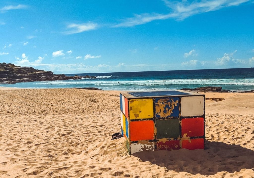 a colorful cube on a beach