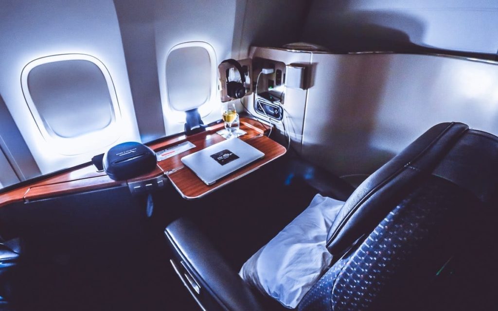 a table with a laptop on it in a plane