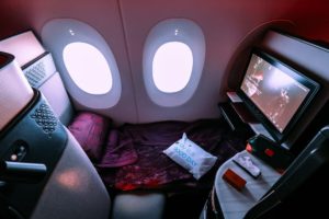 a tv and a bed in a plane