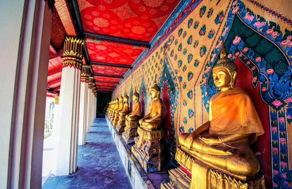 a row of gold statues in a temple