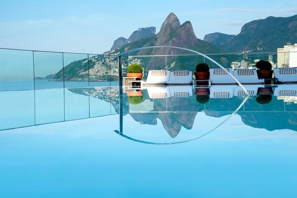 a pool with a view of mountains and city