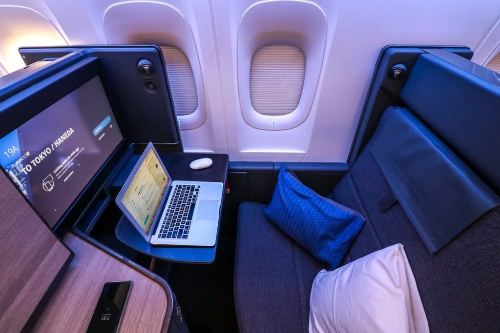 a laptop on a desk in an airplane