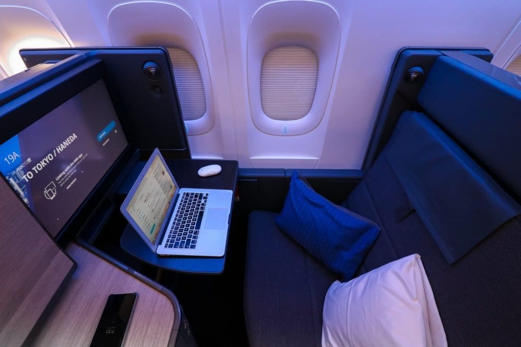 a laptop on a desk in a plane