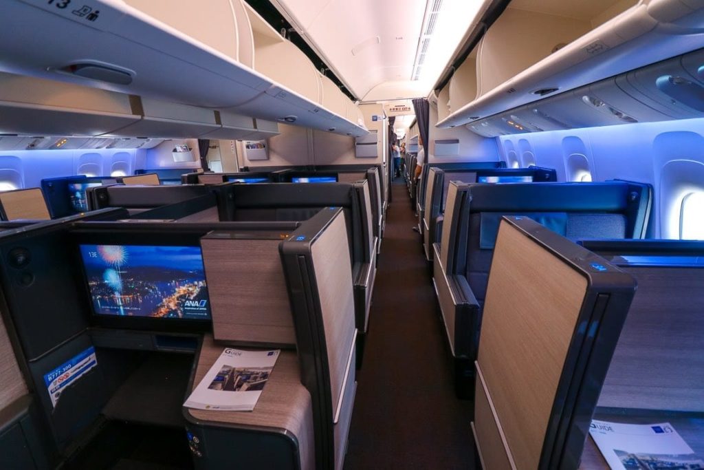 a row of seats with tvs on the side