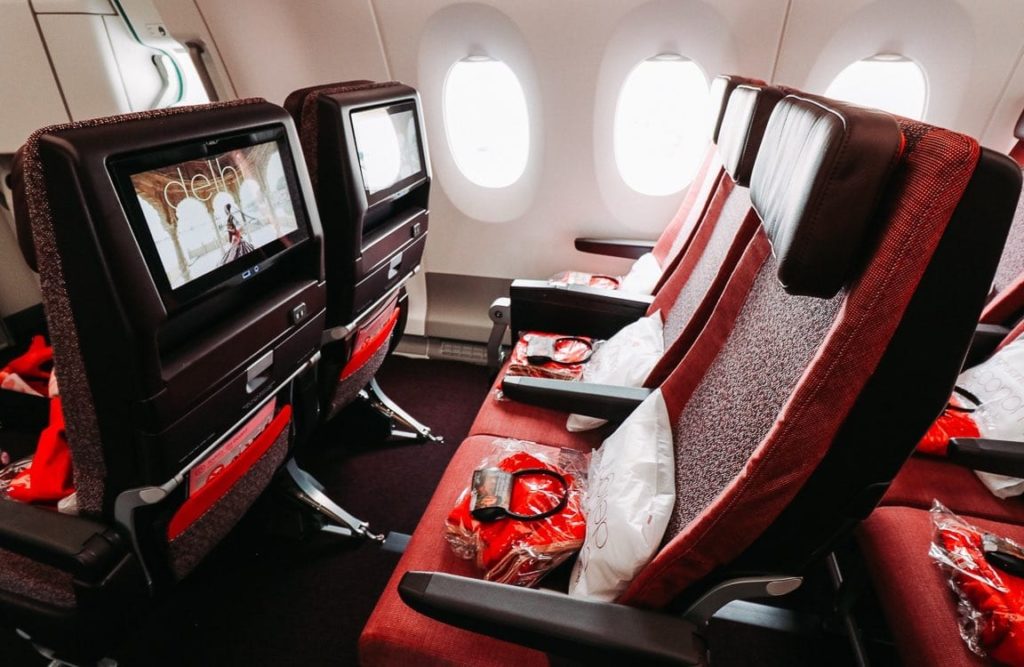 seats in an airplane with a television screen
