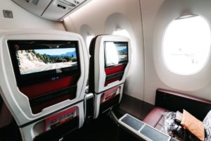 a seats in a plane with two monitors