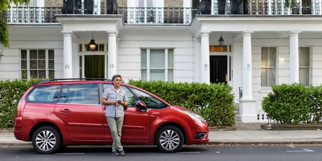 a man leaning against a car