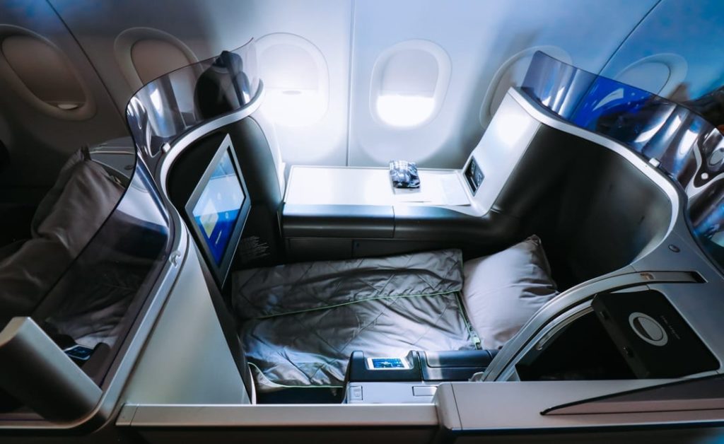 an airplane with a bed and a screen