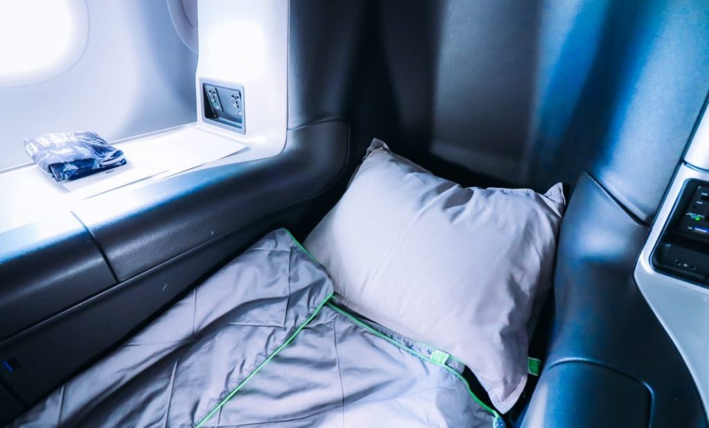 a pillow and blanket in a plane
