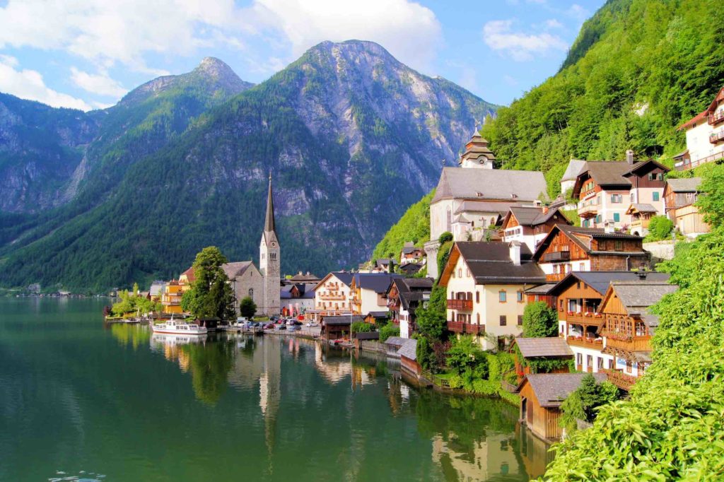 a town on the water with Hallstatt in the background