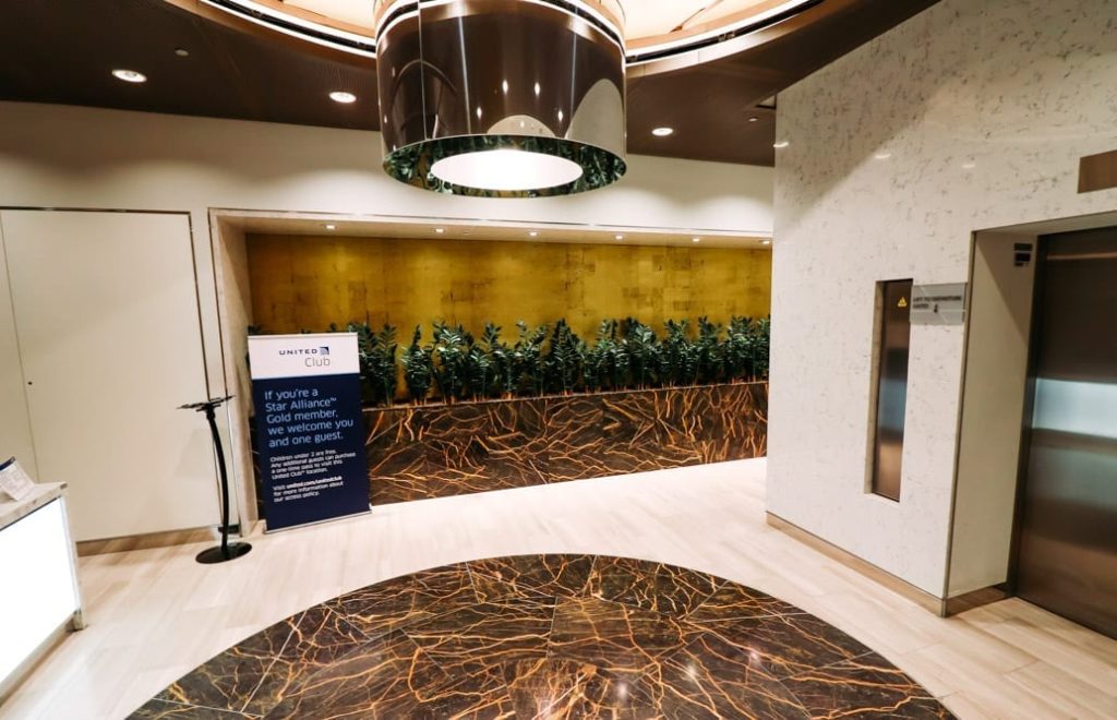 a lobby with a marble floor and a sign