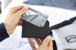 a person holding a credit card in their wallet