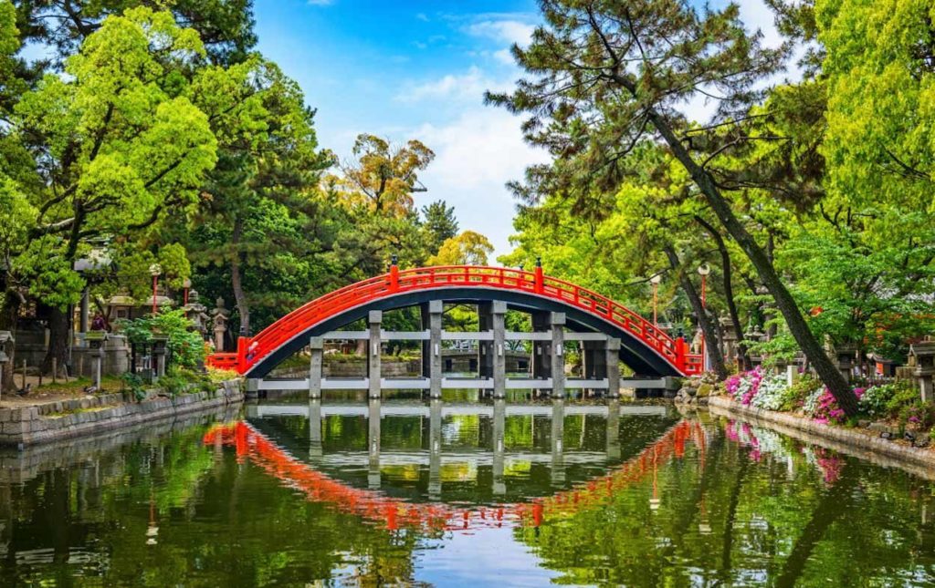 a red bridge over water